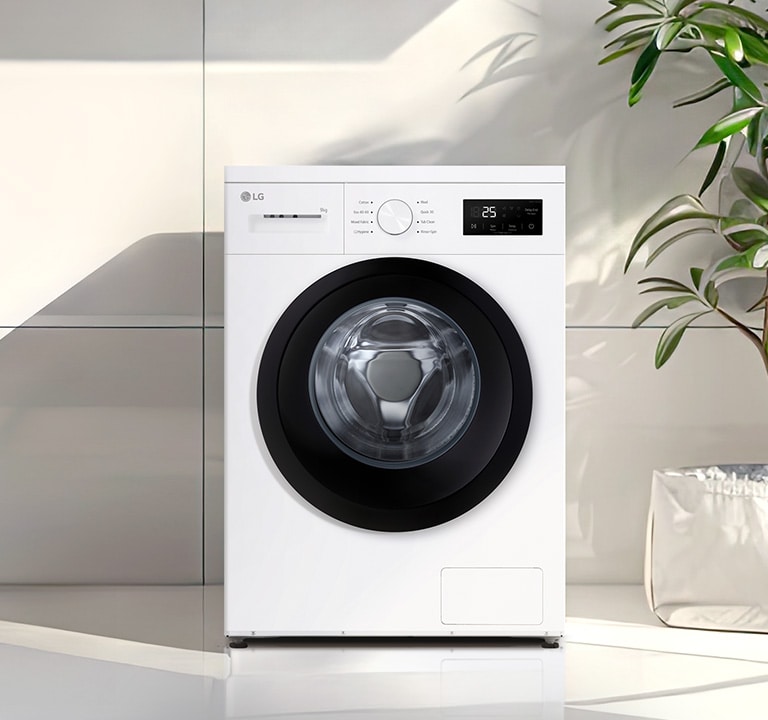  Edestä täytettävä pesukone moderniin pyykinpesutilaan asetettuna