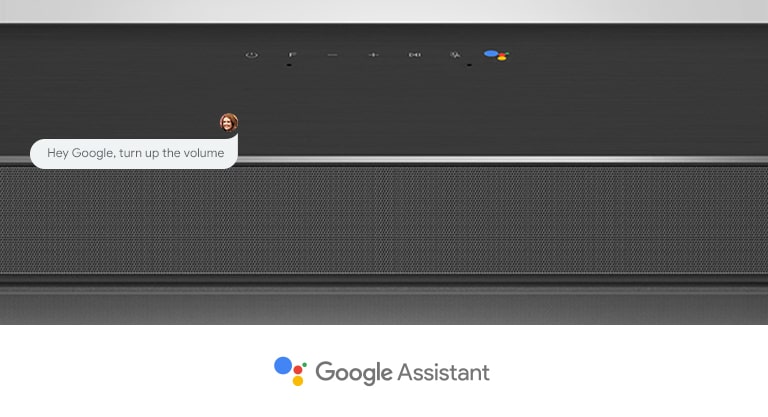 Lähikuva LG-soundbar-kaiuttimen keskiosasta, jossa on ääniohjauspainikkeet ja Google Assistant -logo. Ääntä kovemmalle Googlen ääniohjauksella. 
