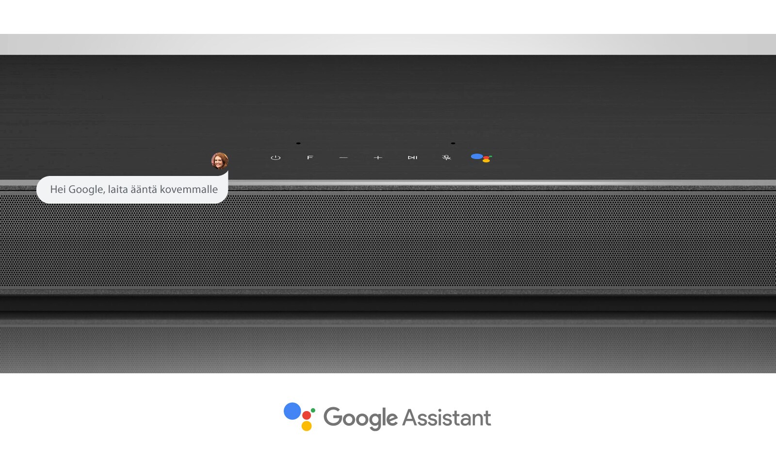 Lähikuva LG-soundbar-kaiuttimen keskiosasta, jossa on ääniohjauspainikkeet ja Google Assistant -logo. Ääntä kovemmalle Googlen ääniohjauksella. 