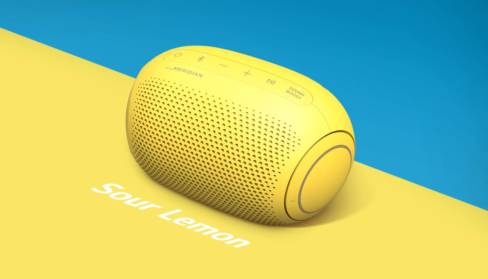 A lemon flavored Jellybean of LG XBOOM Go PL2S is placed on a blue and yellow background.