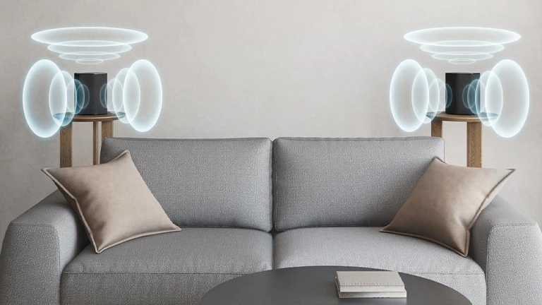 Kaksi takakaiutinta on sijoitettu sohvan vasemmalle ja oikealle puolelle. Ääniaaltografiikat tulevat ulos takakaiuttimista.