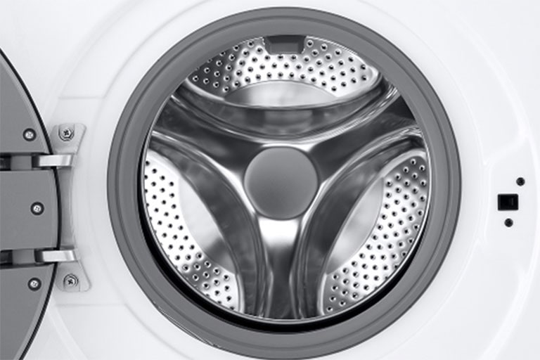 Lähikuva pesukoneen rummusta, jonka ovi on auki