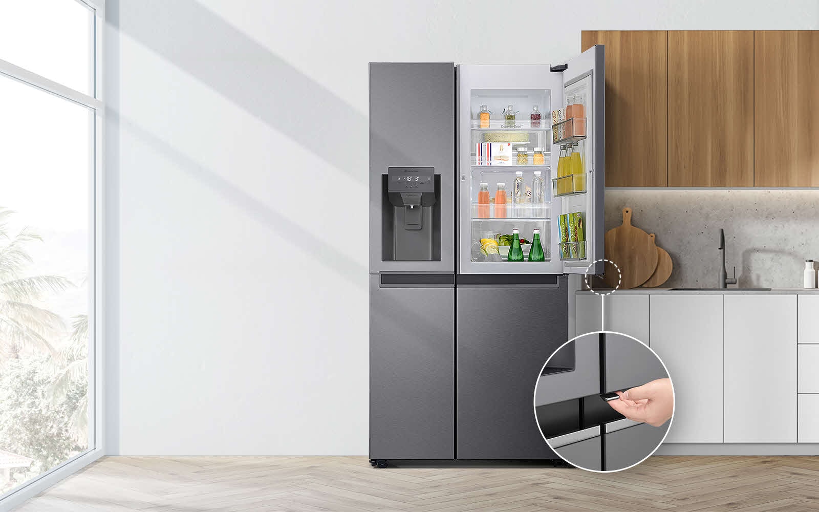A front view of the refrigerator installed in a kitchen. The top right door is open and there is a circle and a line leading to a larger circle that shows a magnified view of the button on the bottom left corner of the open door which has a concealed opening button.