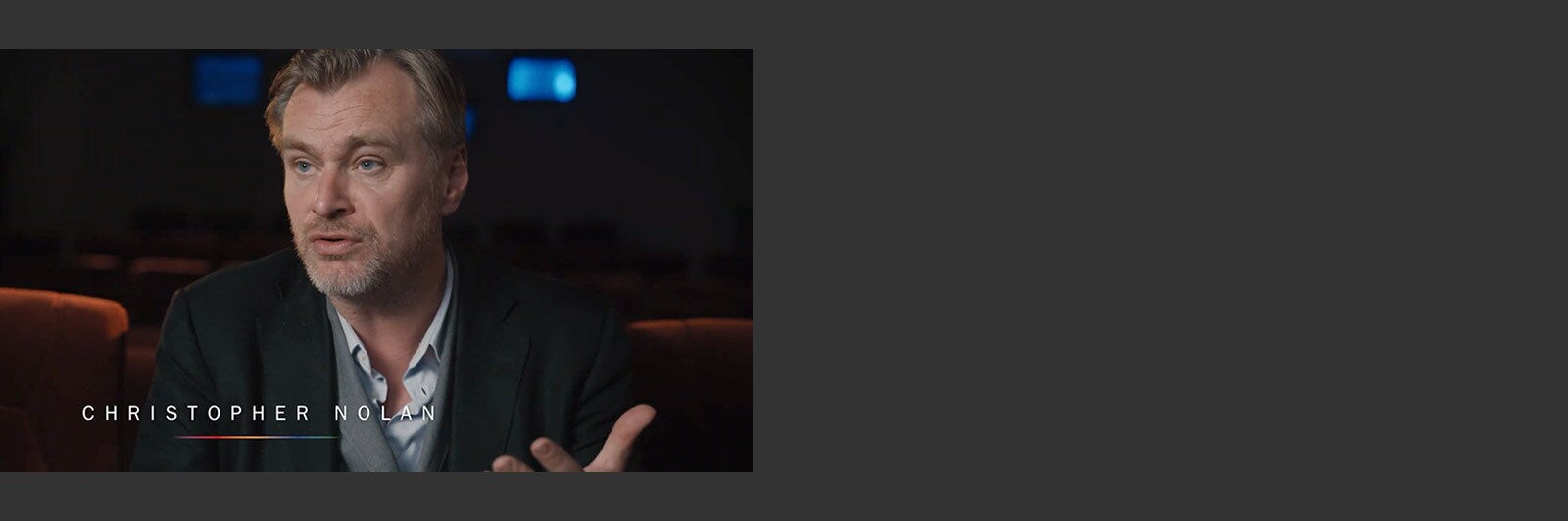 Christopher Nolan doing an interview in a theatre room