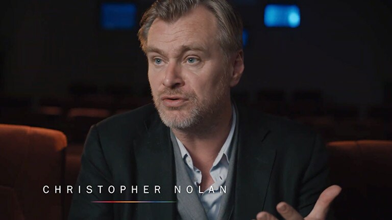 Christopher Nolan doing an interview in a theatre room