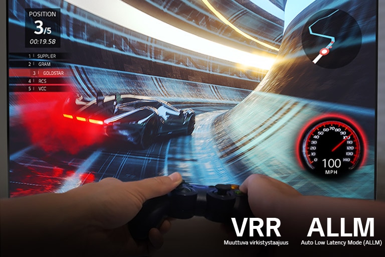 Screen of a racing game with two hands holding a game controller in front of it 