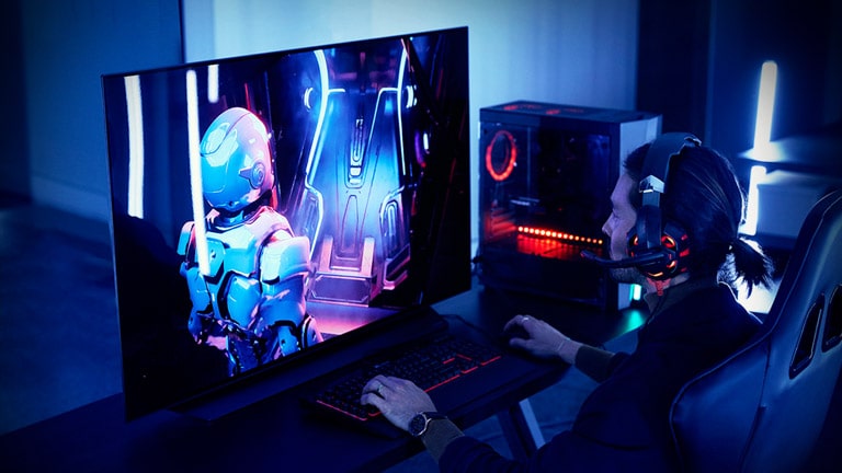 A gaming station setup with a 48-inch TV, desk and chair