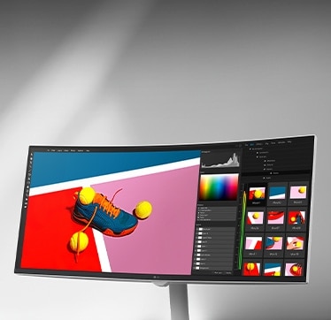 Kaarevalla näytöllä näkyy pirteä talvikohtaus, jossa on kaksi ihmistä oransseissa talvivaatteissa, ja se näkyy kuvankäsittelyohjelman käyttöliittymässä, jossa on väri- ja histogrammivälineitä, ja sRGB 99%:a ja HDR-tukea korostetaan.	