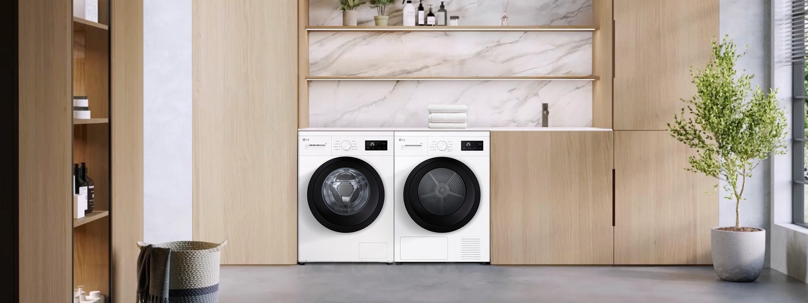 Edestä täytettävä pesukone ja kuivausrumpu pyykinpesutilassa