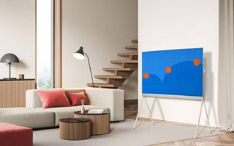 Un salon moderne et épuré doté d’une télévision LG OLED sur un support minimaliste, conçu pour se fondre parfaitement dans un décor contemporain.