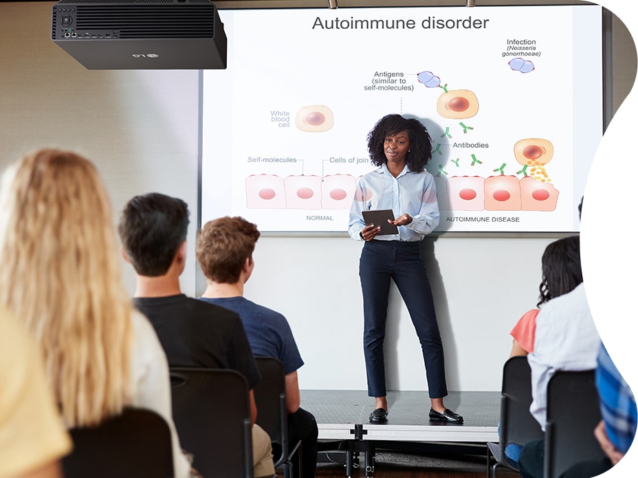 An instructor is teaching using the LG ProBeam Signage Projector. Thanks to its big and bright screen, every student can concentrate more easily.