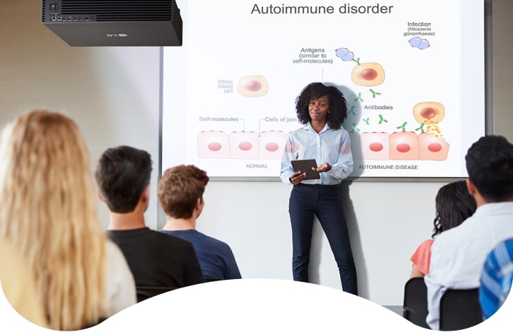 An instructor is teaching using the LG ProBeam Signage Projector. Thanks to its big and bright screen, every student can concentrate more easily.
