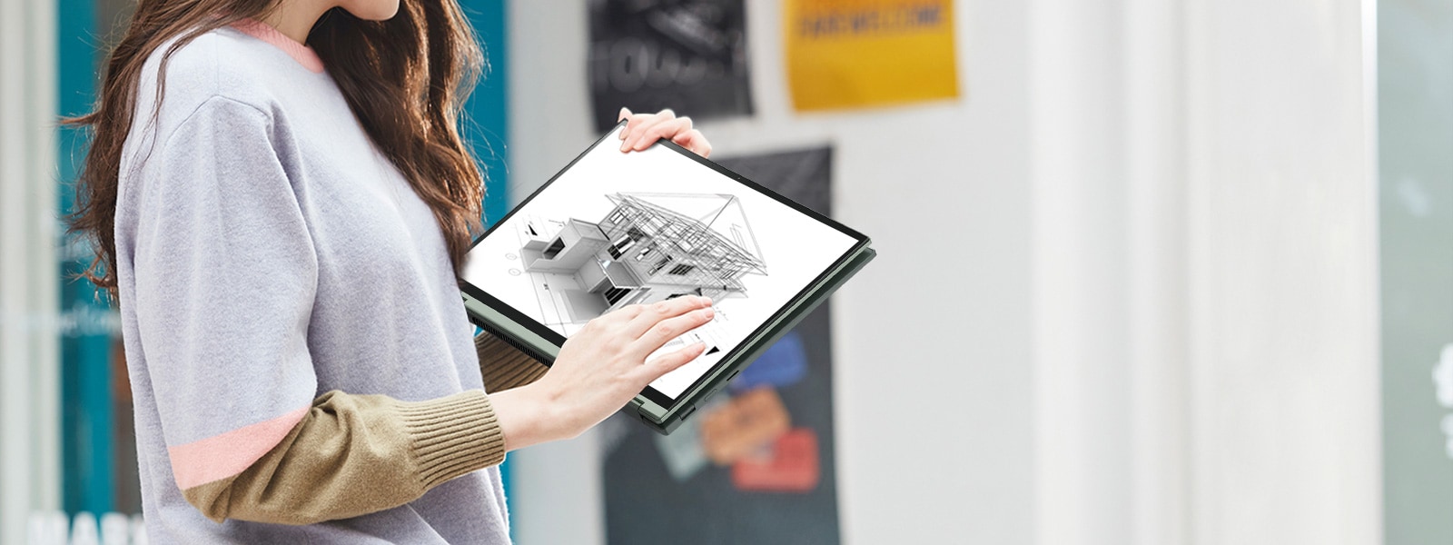 A woman is carrying her LG gram2in1, while she checking a design work on it on the way. 