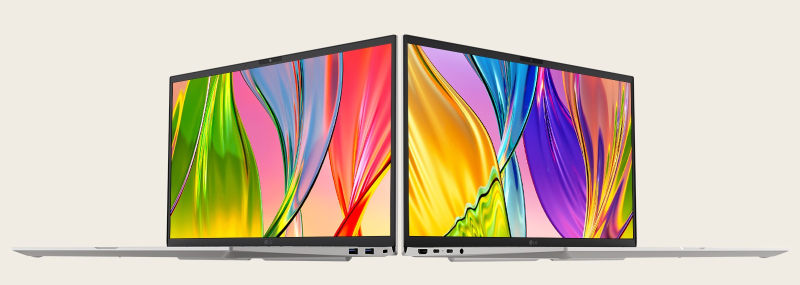 The image features two laptops placed back-to-back, showcasing vibrant, colorful screens with thin bezels, emphasizing vivid visuals and sleek design.