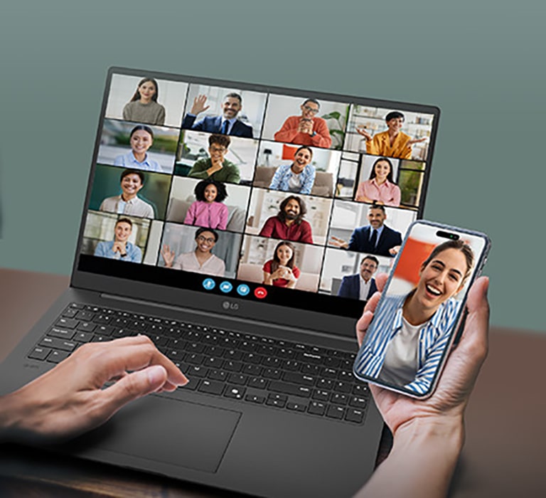 A laptop displaying a video conference with multiple participants on the screen, accompanied by a smartphone showing an individual participant in the same call. This setup emphasizes seamless connectivity and multitasking for virtual meetings.	
