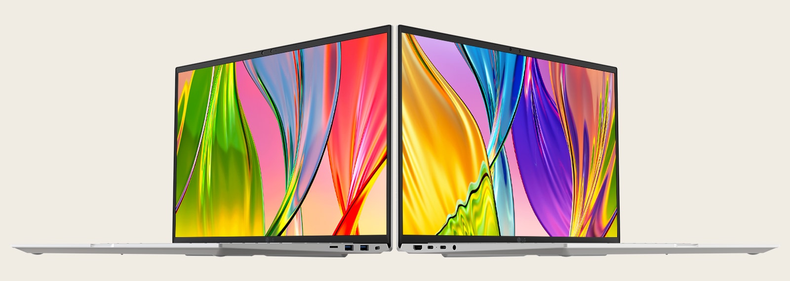 The image features two laptops placed back-to-back, showcasing vibrant, colorful screens with thin bezels, emphasizing vivid visuals and sleek design.	