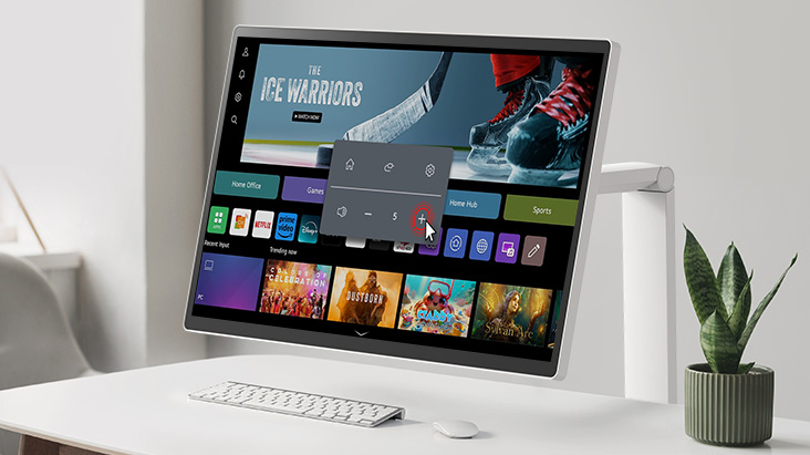 The LG Smart Monitor Swing screen shows the webOS interface, and the volume is being turned up.	