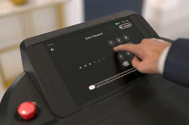 A man grabs the bottle of water in the storage of cloi servebot.	