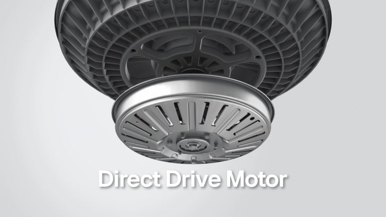 A close-up image of a washing machine's direct drive motor. The motor is shown from below, with its circular base and internal components visible.