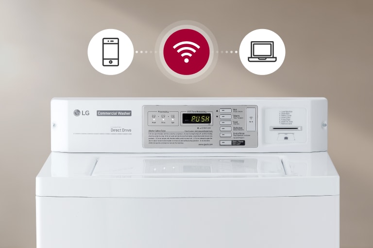 A white commercial washing machine with a digital control panel. A smartphone, a Wi-Fi symbol, and a laptop are shown connected to the machine, indicating its smart connectivity features.