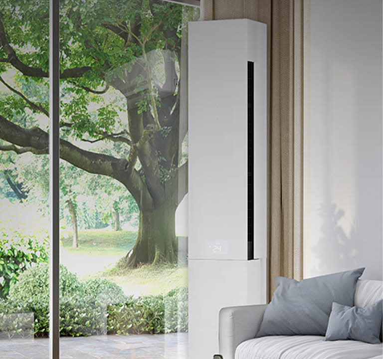 Bright living room with a large window and an floor-standing air conditioner installed beside a sofa, blending into the modern home interior for residential cooling.