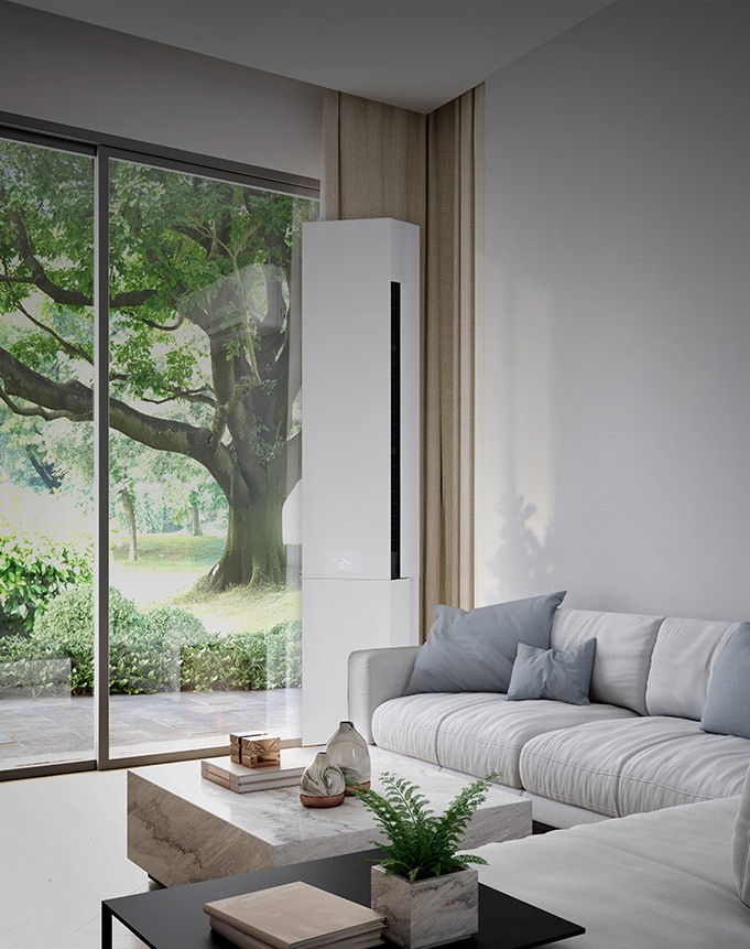 Bright living room with a large window and an floor-standing air conditioner installed beside a sofa, blending into the modern home interior for residential cooling.