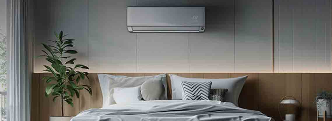 Contemporary bedroom featuring an wall-mounted air conditioner above the bed, providing quiet and efficient cooling in a cozy, natural-toned space.