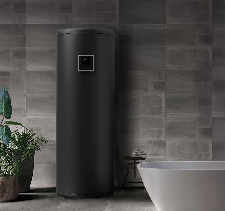 Matte black cylindrical Air to Water Heat Pump installed indoors against a tiled wall, next to a modern white bathtub.