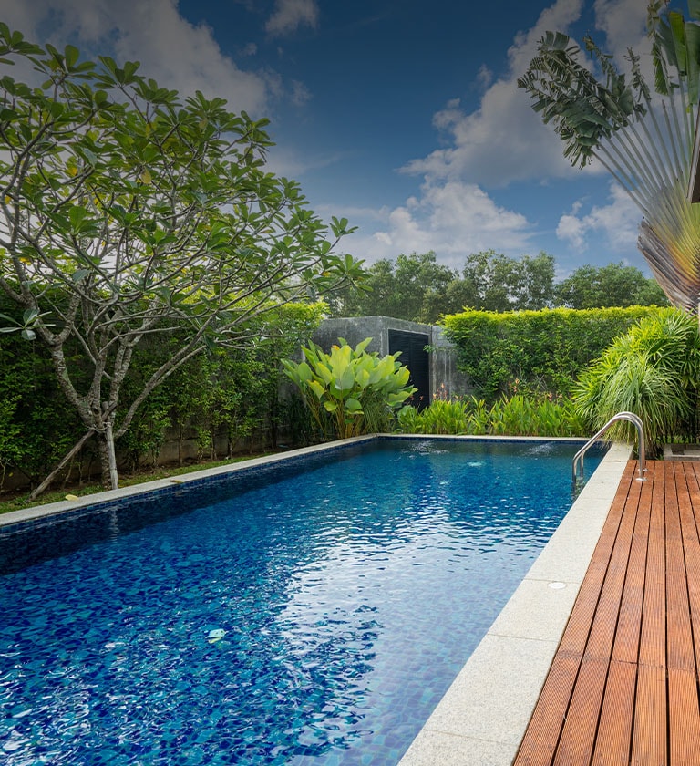 swimming pool and decking in garden of luxury home