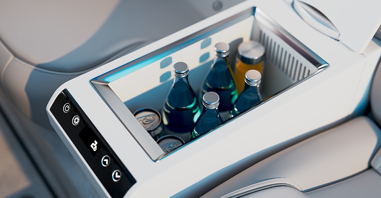 An in-car refrigerator, filled with chilled drinks, sits in the backseat, ready for a road trip.