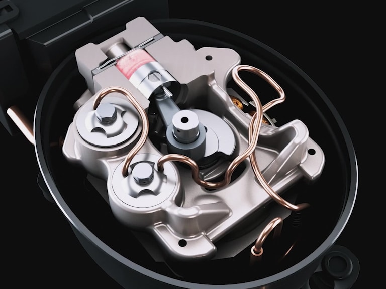 Close-up of LG fixed speed reciprocating compressor interior showing detailed components, including coils, gears, and copper tubing on a dark background.