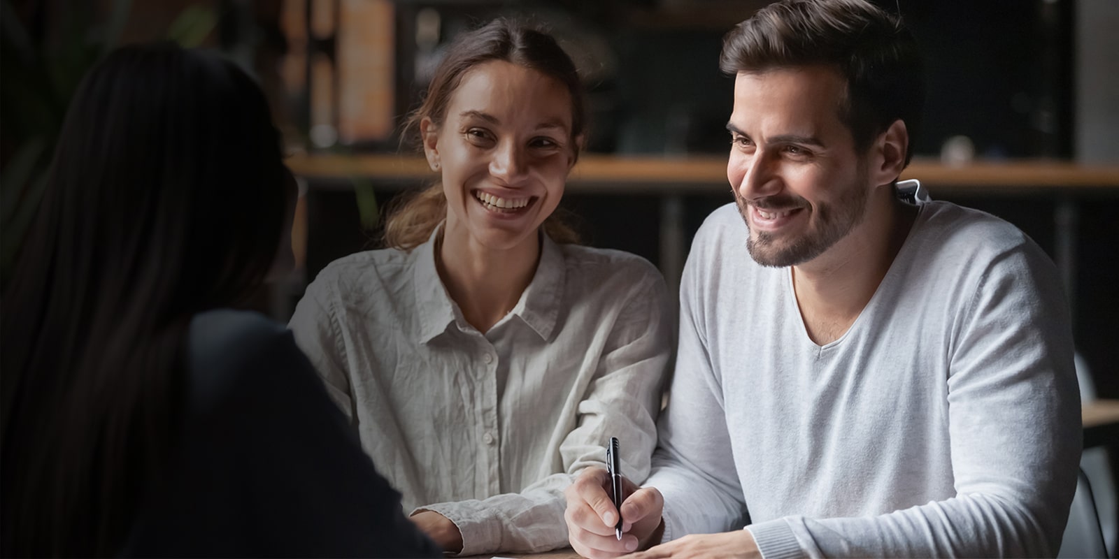 A man and a woman talk to a woman facing each other