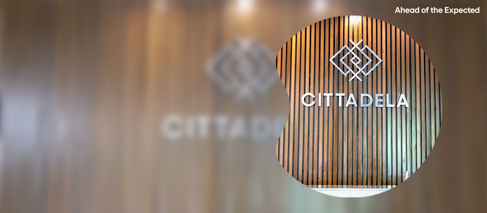 Cittadela logo on wooden slat wall with magnified detail and slogan 'Ahead of the Expected