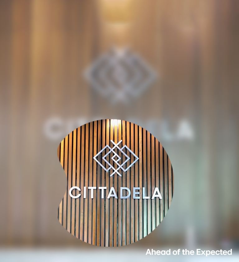 Cittadela logo on wooden slat wall with magnified detail and slogan 'Ahead of the Expected