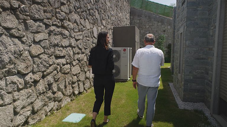 A woman and a man walking in the garden