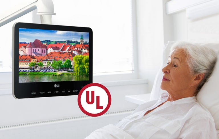 The patient is lying in the bed and watching the UL-listed TV.
