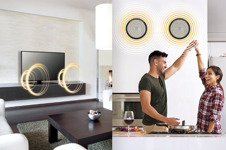 TV in a living room is making a sound and a man and a woman in the kitchen are listening the sound of TV through external speakers.