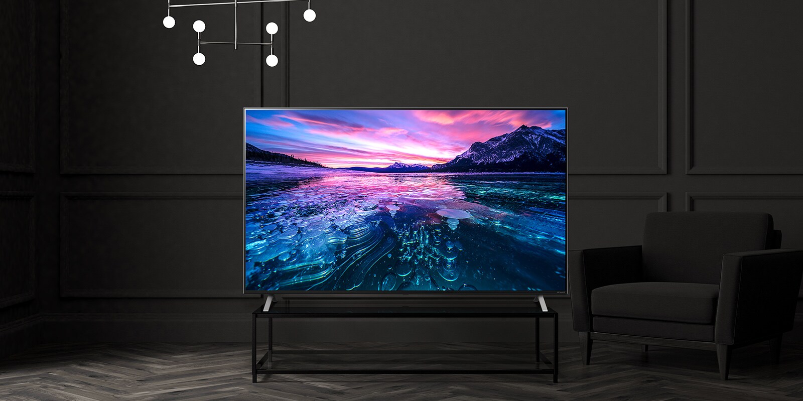 A TV on the hotel table shows a vivid and bright screen.