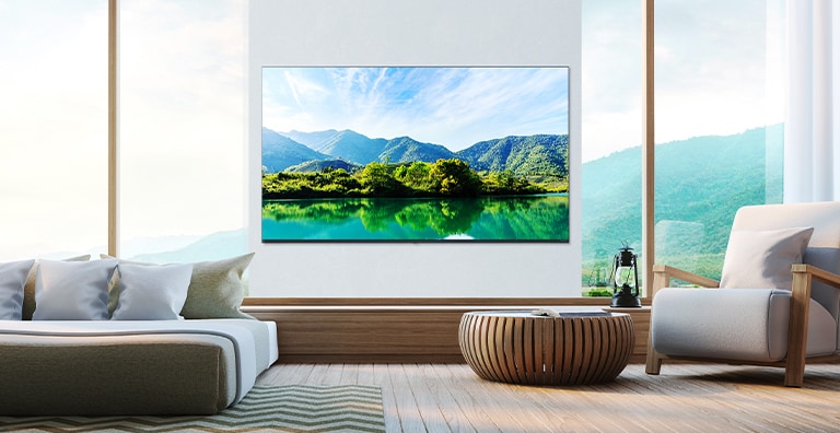 A TV is hanging on the wall of the hotel room, and the scenery shown on the TV screen is bright and clear.