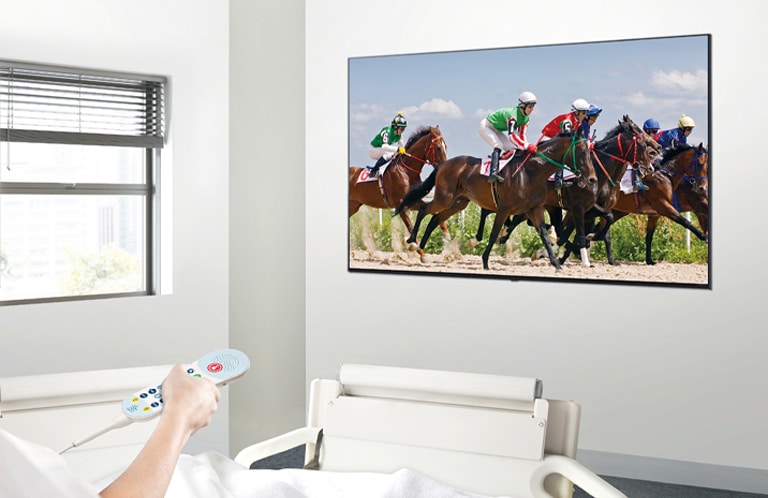 A patient in the hospital room is watching VOD on a TV hanging on the wall without a set-top box.