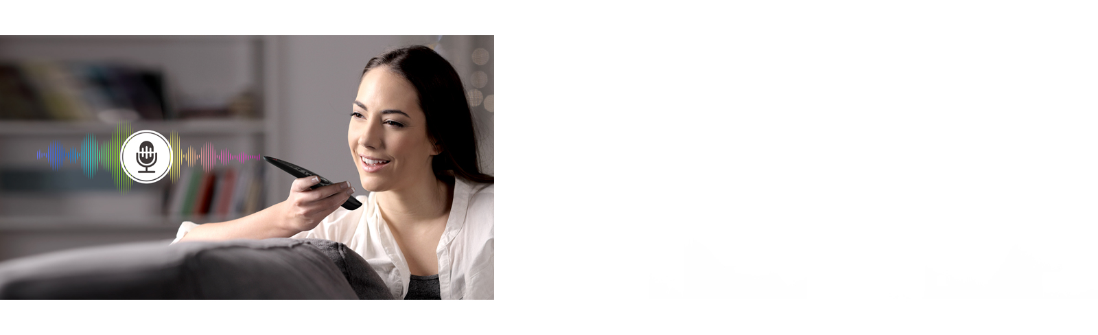 A woman is controlling TV by speaking to a remote control which has voice recognition.