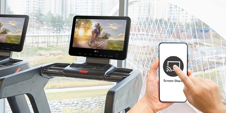 A smart phone screen is being shared wirelessly on a TV installed on a treadmill.