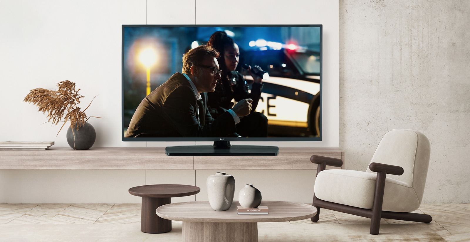 A TV by a hotel’s wall shows a bright and vivid screen.