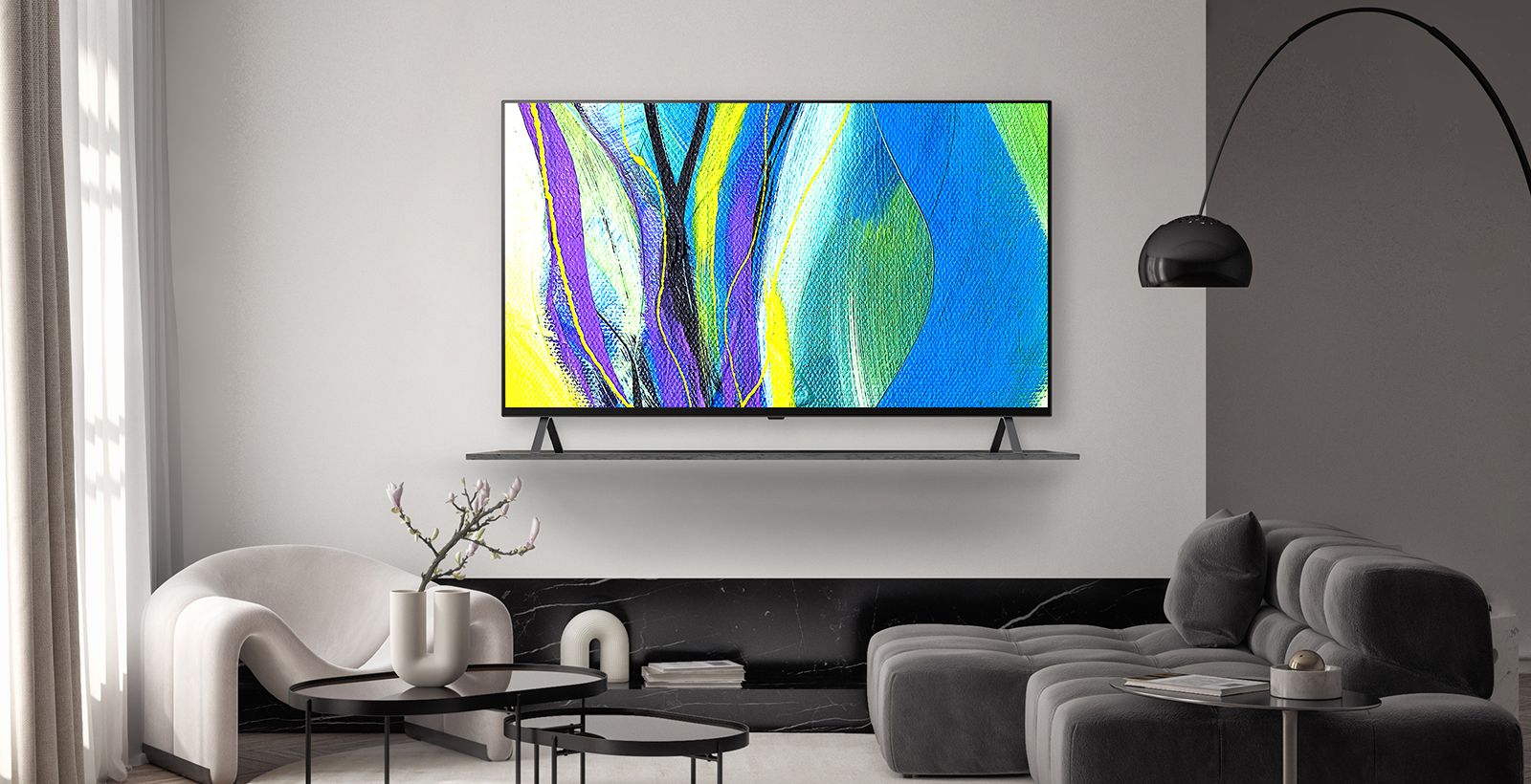 A TV is framed on a hotel wall’s shelf, and the TV screen shows works of art.