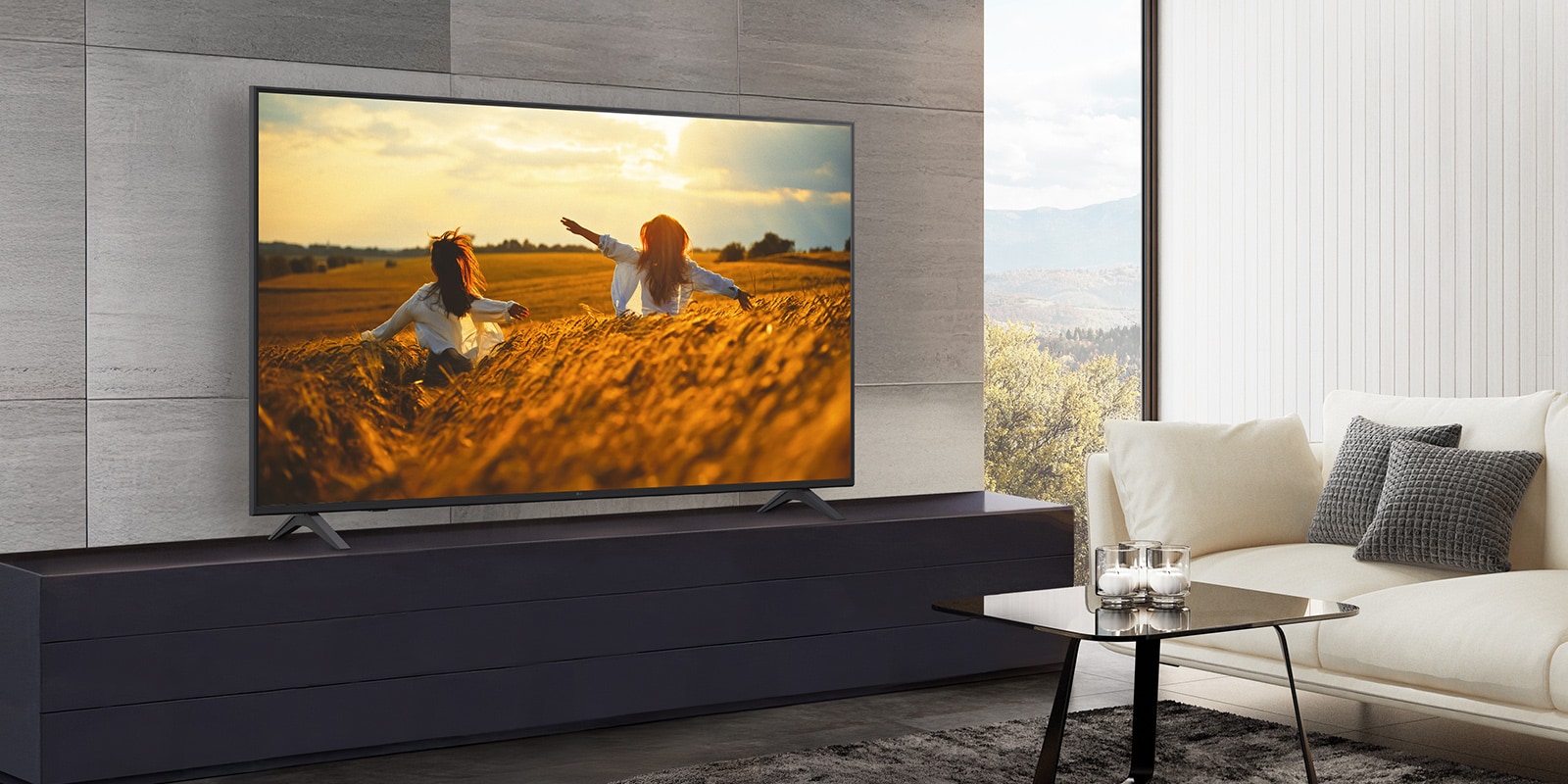 A TV is placed on a stand against the wall in the hotel room, and the screen is bright and clear.
