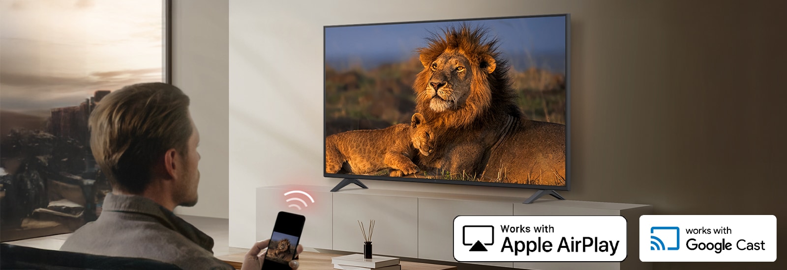 A hotel guest is casting content from a smartphone to the in-room TV using wireless casting technologies such as AirPlay and Google Cast.