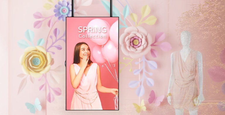 The slim bezel display installed next to a mannequin in a shop window clearly shows the promotional ads to customers.