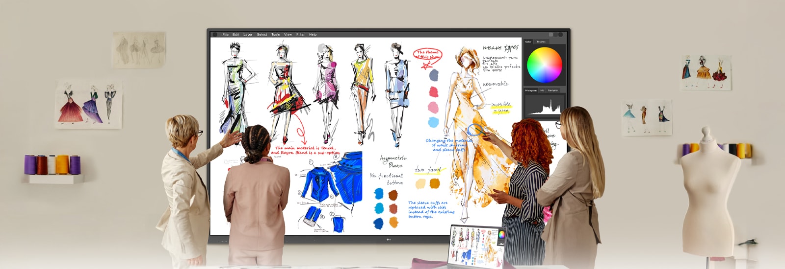 In a studio workspace, a group collaborates by writing directly onto a large wall-mounted smart whiteboard during a discussion.