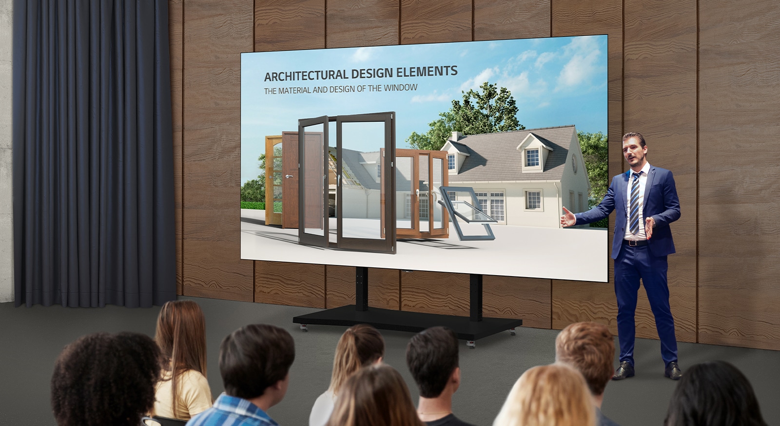 A man explains content on the screen of an LAEC installed with a dedicated stand in an auditorium.