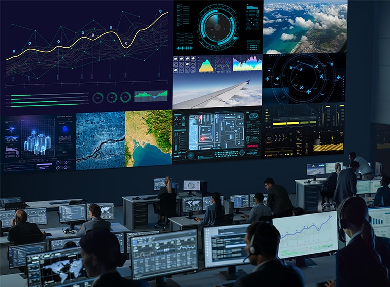 The control room has a large screen that is divided into sections, providing detailed and clear information. It is being monitored by a large number of people.